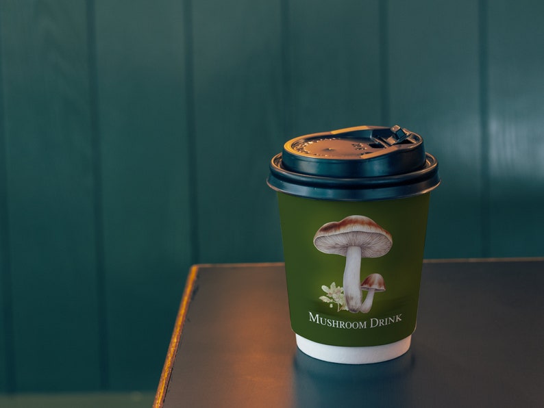 May include: A green paper cup with a black lid and a mushroom illustration. The cup says "Mushroom Drink" on the bottom.