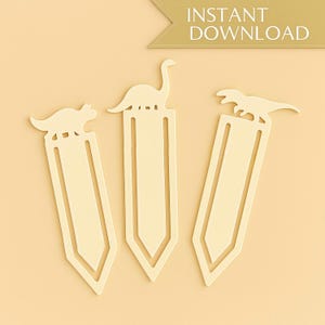 May include: Three cream-colored dinosaur-shaped bookmarks. Each bookmark features a different dinosaur silhouette atop a rectangular body with a pointed bottom. The words "INSTANT DOWNLOAD" are in a banner in the top right corner.