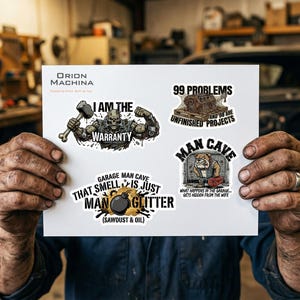 May include: A sheet of stickers with various designs. One sticker reads "I AM THE WARRANTY" with a muscular skull figure. Other stickers say "99 PROBLEMS AND 98 ARE UNFINISHED PROJECTS", "MAN CAVE", and "GARAGE MAN CAVE THAT SMELL IS JUST MAN GLITTER".
