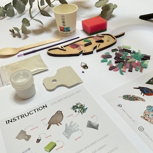 May include: A DIY mosaic art kit with a wooden feather-shaped mold, colorful glass tiles, and instructions. The kit includes a spatula, sponge, gloves, grout, and fixing glue.