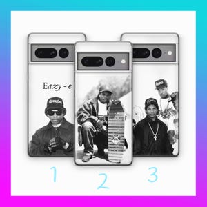 May include: Three black and white phone cases featuring different images of rappers. The first case features a rapper wearing a Champion hat and holding a microphone. The second case features a rapper wearing a baseball cap and holding a skateboard. The third case features two rappers, one wearing a baseball cap and the other wearing a backwards baseball cap. The text "Eazy-e" is printed on the first case.