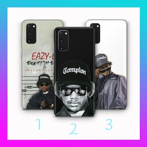 May include: Three different phone cases featuring a black and white illustration of a rapper wearing a black baseball cap with the word "Compton" on it. The first case features a black and white mugshot of the rapper with the text "Eazy-E" and "Str8 off tha-St of W.U.T.H.A.P.H.U*" above it. The second case features a close-up of the rapper's face. The third case features a full-body illustration of the rapper.