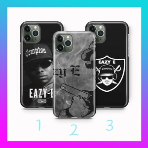 May include: Three different iPhone cases with black and white designs. The first case features a black and white photo of a rapper with the text "Eazy-E" and "Compton". The second case features a black and white photo of a rapper with the text "Eazy-E" and a gun. The third case features a black and white logo of a rapper with the text "Eazy-E" and "Compton".