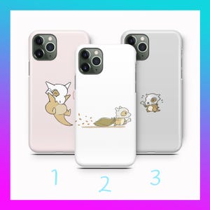 May include: Three phone cases with cartoon illustrations. The first case is light pink with a Cubone character. The second case is white with a Cubone character running. The third case is gray with a Cubone character.