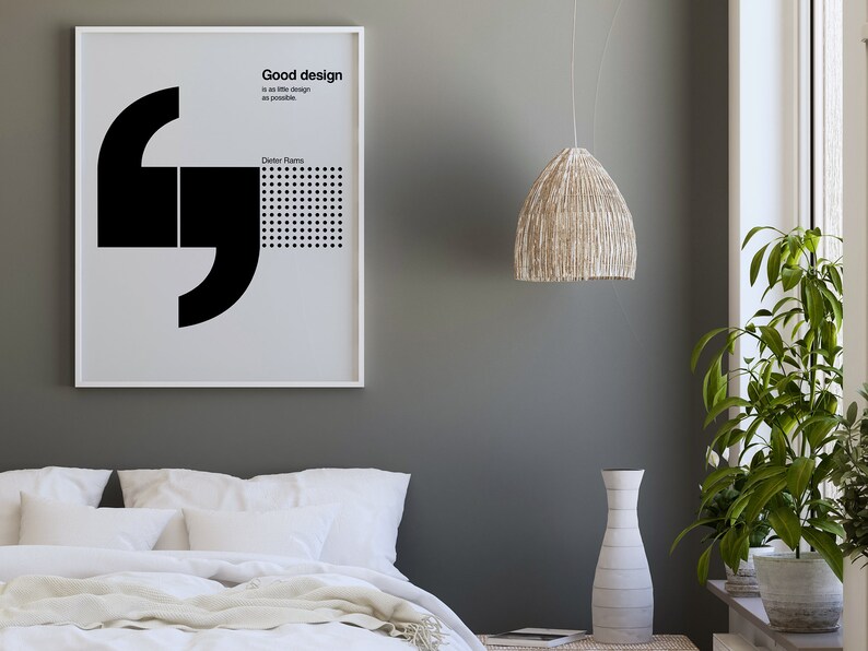 May include: A framed black and white poster with a quote by Dieter Rams: "Good design is as little design as possible."