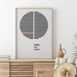 Op de afbeelding: Een ingelijst zwart-wit minimalistisch poster met een cirkelvormig ontwerp en de tekst "Minder, maar beter".
