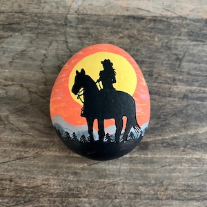 Cowgirl riding a horse in sunset, painted rocks, horse rock