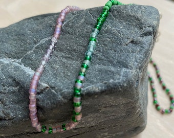 Beaded necklace green and purple seed beads with highlights of amethyst and apatite gemstones.