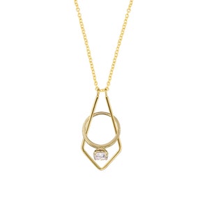May include: A gold necklace with a geometric pendant that holds a ring with a clear stone.