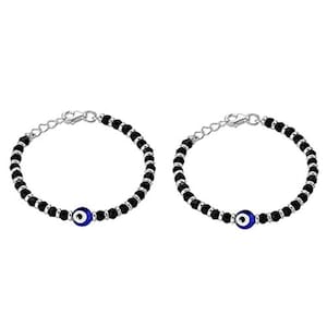 May include: Two black beaded bracelets with silver accents and blue evil eye charms.