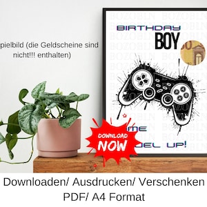 Puede incluir: Impresión en blanco y negro enmarcada con un diseño de mando de videojuegos, las palabras "BOY" y "BIRTHDAY" son visibles. Un gráfico de explosión roja dice "DOWNLOAD NOW". La impresión está en una estantería de madera con una planta en maceta.