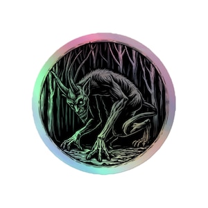 May include: A black and white illustration of a horned creature with a menacing expression, crouching in a dark forest. The illustration is surrounded by a holographic circle with a rainbow gradient.