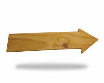 May include: A wooden arrow sign, pointing right, with a natural wood grain finish. The arrow is a light brown color and has a simple, clean design. The sign is ideal for home decor or directional signage.
