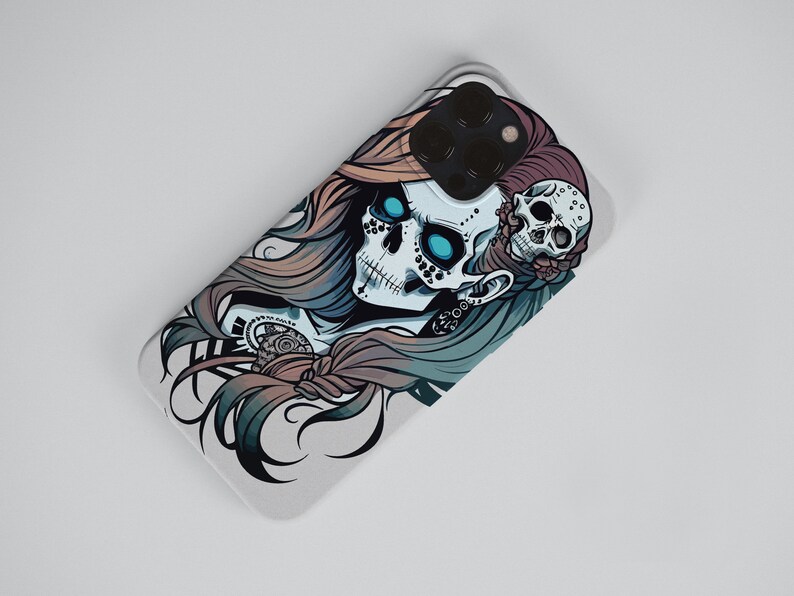 May include: A white phone case with a colorful illustration of a skull with blue eyes and long hair. The skull is wearing a flower crown and has a smaller skull on the side of its head.