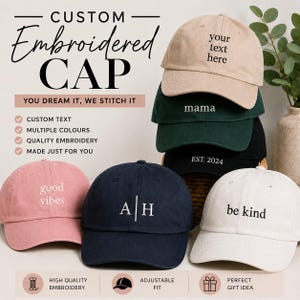 May include: A collection of six baseball caps in various colours including beige, dark green, black, pink, navy blue, and white. Each cap features custom embroidery with text such as your text here, mama, EST. 2024, good vibes, A | H, and be kind.