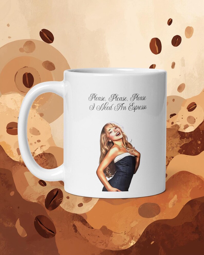 May include: A white ceramic mug featuring a graphic of a person with long blonde hair wearing a dark strapless top. Above the graphic, the text reads, "Please. Please. Please I Need An Espresso" in a black cursive script font on the mug surface.