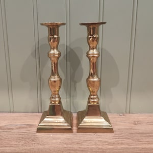 Pair of vintage brass candle sticks - 22 centimeters tall.