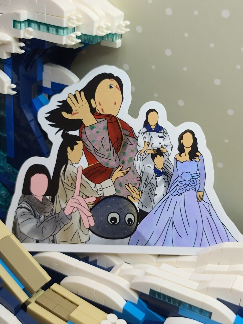May include: A sticker featuring a group of cartoon figures, including a woman in a red and floral patterned jacket, a woman in a blue gown, and a gray rock with eyes. The sticker is set against a backdrop of a Lego wave.
