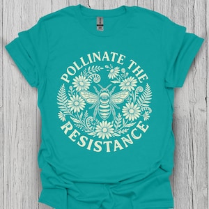 Maglietta "Pollinate The Resistance" con grafica di api, tema floreale ambientalista e cottagecore.