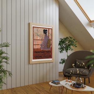 May include: A framed poster with a red background and a woman in a purple dress standing in front of a Japanese garden. The poster reads "Madame Butterfly" and "Giacomo Puccini".