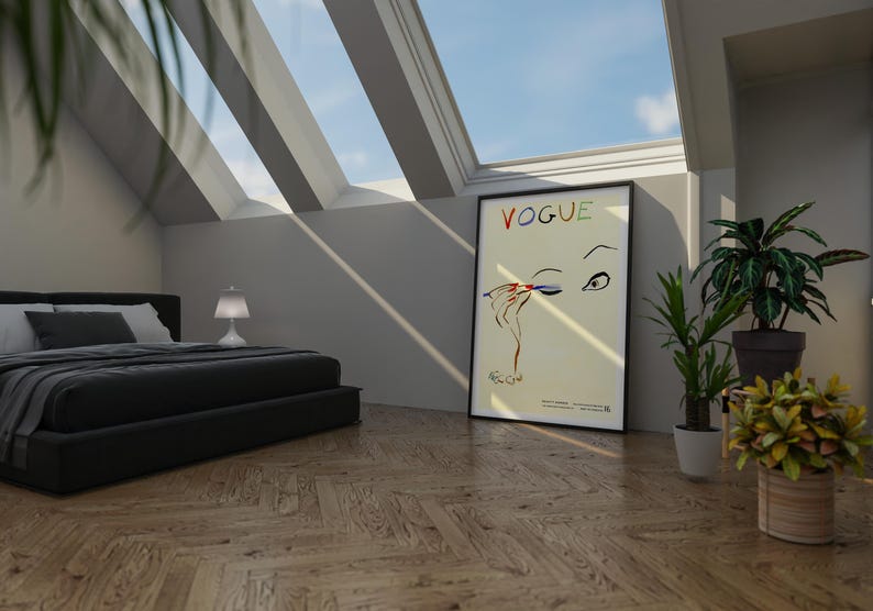 May include: A bedroom scene with a black bed, a Vogue poster, and potted plants. The Vogue poster features an illustration of an eye and hand applying makeup. The room has a wooden floor and a skylight.