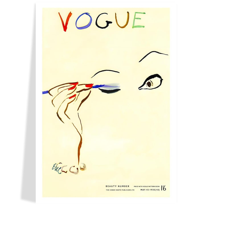 May include: Vintage Vogue magazine cover art featuring a woman applying blue eyeliner. The word "VOGUE" is written in red, blue, brown, and green. The woman's hand has red nail polish. The cover is from May 15, 1935.