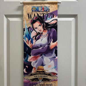 May include: A One Piece wall scroll featuring Nico Robin. The artwork depicts Nico Robin in a purple jacket and white dress, with a determined expression. The scroll includes the text "WANTED" and "NICO-ROBIN", along with Japanese text and a monetary value.