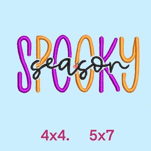 May include: Purple and orange embroidery design with the text "Spooky season" in black.