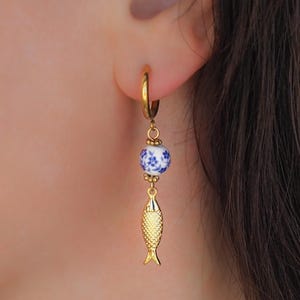 Gold Sardine Earrings with Ceramic Tile from Portugal in ear model - Coastal Jewelry from Portugal, seabylou, Sea by Lou, Fish earrings