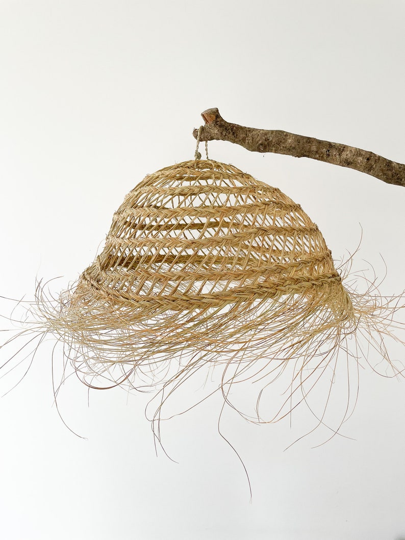 round pendant light in natural fiber image 1