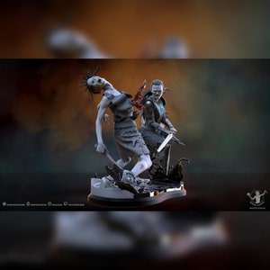 May include: A gray painted figurine of two figures, one with a sword and the other with a knife, standing on a black base. The figure with the sword has a red and black design on its chest.