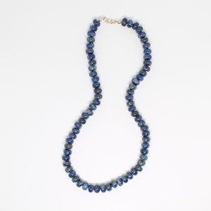 May include: A blue lapis lazuli beaded necklace with a gold clasp.