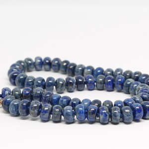 May include: A blue lapis lazuli beaded necklace with a gold clasp.