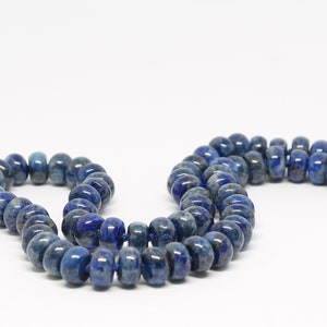 May include: A strand of dark blue lapis lazuli beads, strung on a gold thread.