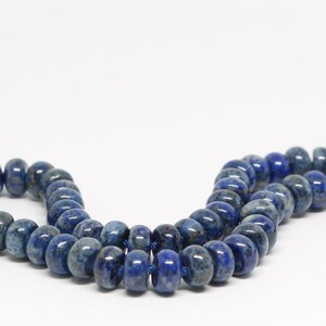 May include: A strand of dark blue lapis lazuli beads. The beads are round and have a smooth, polished finish.