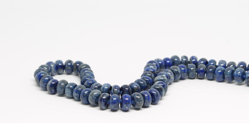 May include: A strand of dark blue lapis lazuli beads. The beads are round and have a smooth, polished finish.