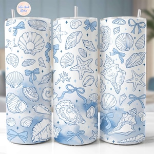 May include: Three stainless steel tumblers with a white background and blue watercolor accents. The tumblers feature a pattern of seashells, starfish, and other ocean-themed designs.