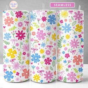 May include: A seamless pattern with colorful flowers and hearts on a white background. The pattern is repeated on three different tumblers.