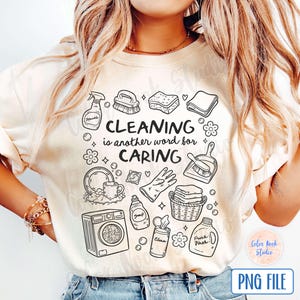 May include: A white t-shirt with a black and white graphic design featuring cleaning supplies and the text "Cleaning is another word for caring".