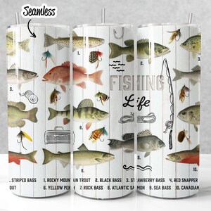 May include: A white tumbler with a woodgrain background and illustrations of different types of fish. The text "FISHING Life" is printed on the tumbler. The tumbler is labeled with the names of the fish, including Striped Bass, Rocky Mountain Trout, Black Bass, Strawberry Bass, Red Snapper, Yellow Perch, Rock Bass, Atlantic Salmon, Sea Bass, and Canadian.