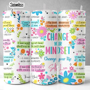May include: Three white tumblers with colorful floral designs and inspirational quotes. The tumblers feature phrases like "Change Your Mindset", "I'm Worthy of Love", and "True Starts".