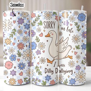 May include: A white tumbler with a floral pattern and a cartoon goose. The text on the tumbler reads "Sorry I'm Late I Was Dilly Dallying".