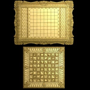 May include: Two ornate, gold-colored game boards. The top board has a grid pattern, while the bottom board features a series of small, detailed symbols. Both boards are framed with decorative, floral-inspired borders and set against a black background.