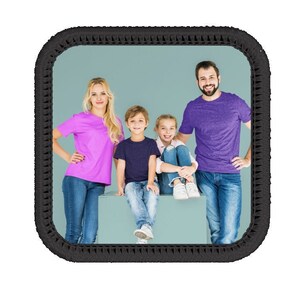 Op de afbeelding: Een gezin van vier poseert voor een foto. De ouders dragen casual kleding, terwijl de twee kinderen jeans en t-shirts dragen. Het gezin staat voor een lichtblauwe achtergrond.