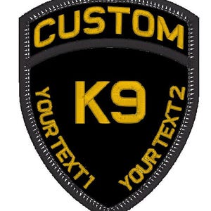 May include: Black and gold embroidered patch with the text "CUSTOM" at the top, "K9" in the centre, and "YOUR TEXT 1" and "YOUR TEXT 2" on the sides.