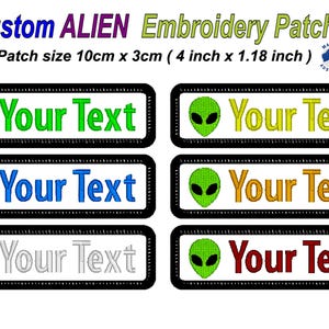May include: Custom embroidered alien patches, each 10cm x 3cm. The patches feature a green alien head and the text "Your Text" in various colours: green, yellow, blue, orange, silver, and red. The patches have a black border.