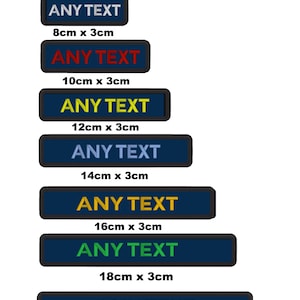 Op de afbeelding: Zeven aangepaste geborduurde patches met de tekst "ANY TEXT" in verschillende kleuren. De patches zijn rechthoekig en hebben een donkerblauwe achtergrond met zwarte randen. De patches zijn verticaal gerangschikt op grootte, met de kleinste patch bovenaan en de grootste patch onderaan. De grootte van elke patch staat eronder vermeld in centimeters.