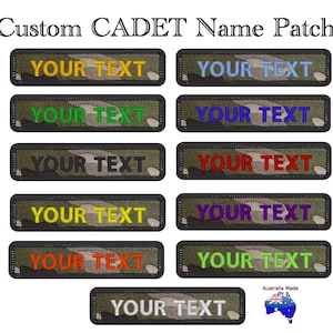 May include: A selection of custom cadet name patches. Each patch has a camouflage pattern and the text "YOUR TEXT" in different colours, such as yellow, blue, green, red, and purple. The patches are rectangular with a black border. The text "Australia Made" is also visible.
