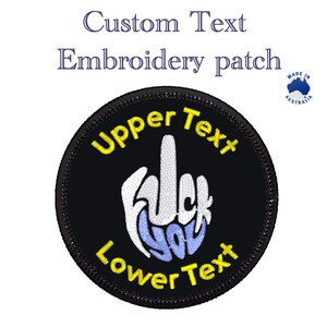 May include: Black embroidered patch with a middle finger and the text "Upper Text" and "Lower Text" in yellow. The middle finger is white with the words "F**k You" in blue.