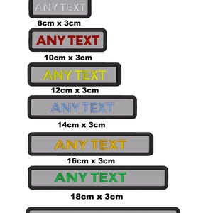 May include: A set of six grey custom patches with black borders. The patches are rectangular and have the text "ANY TEXT" in different colours. The patches are available in six sizes: 8cm x 3cm, 10cm x 3cm, 12cm x 3cm, 14cm x 3cm, 16cm x 3cm, and 18cm x 3cm.